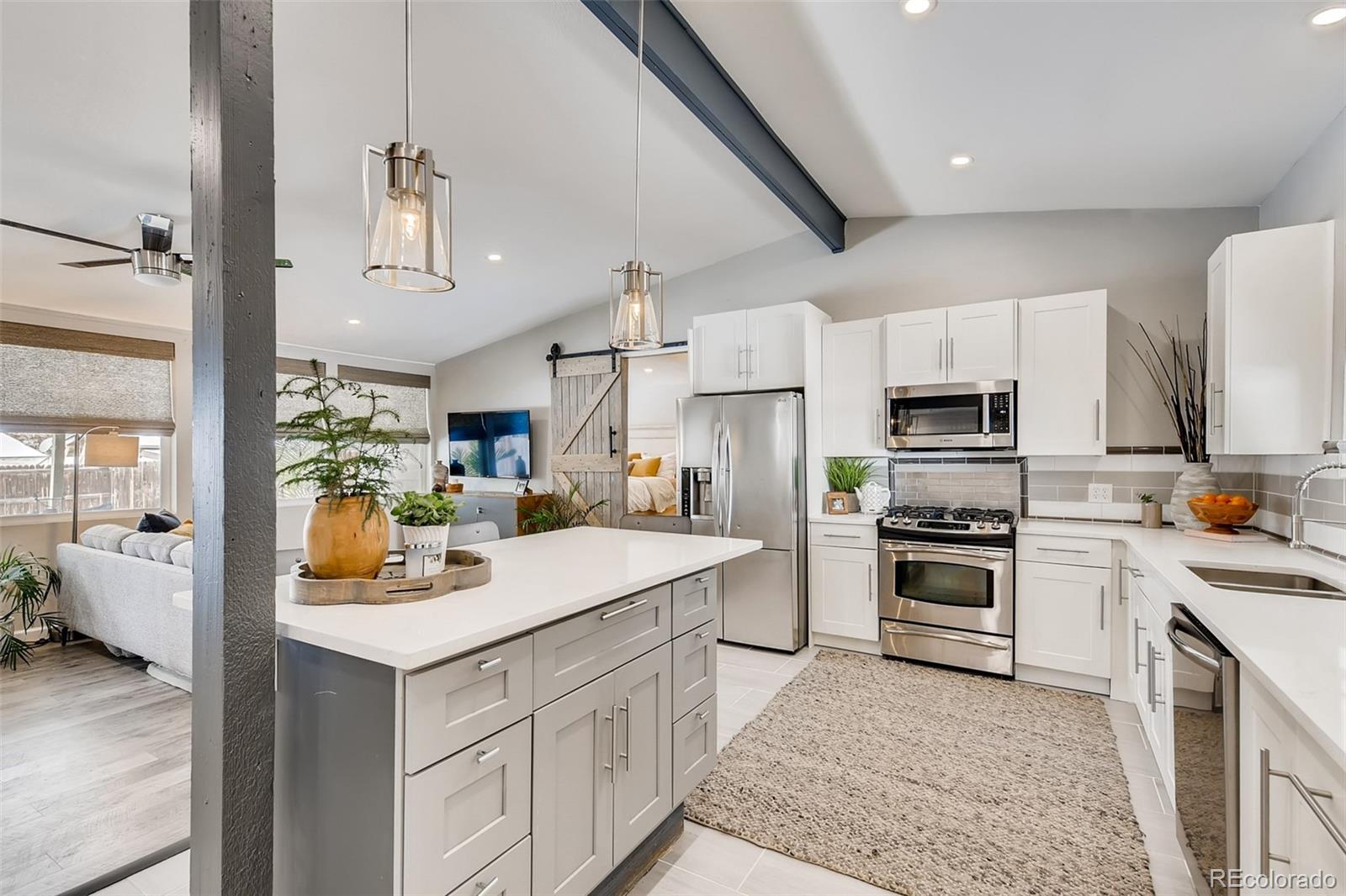 a kitchen with a sink cabinets and stainless steel appliances