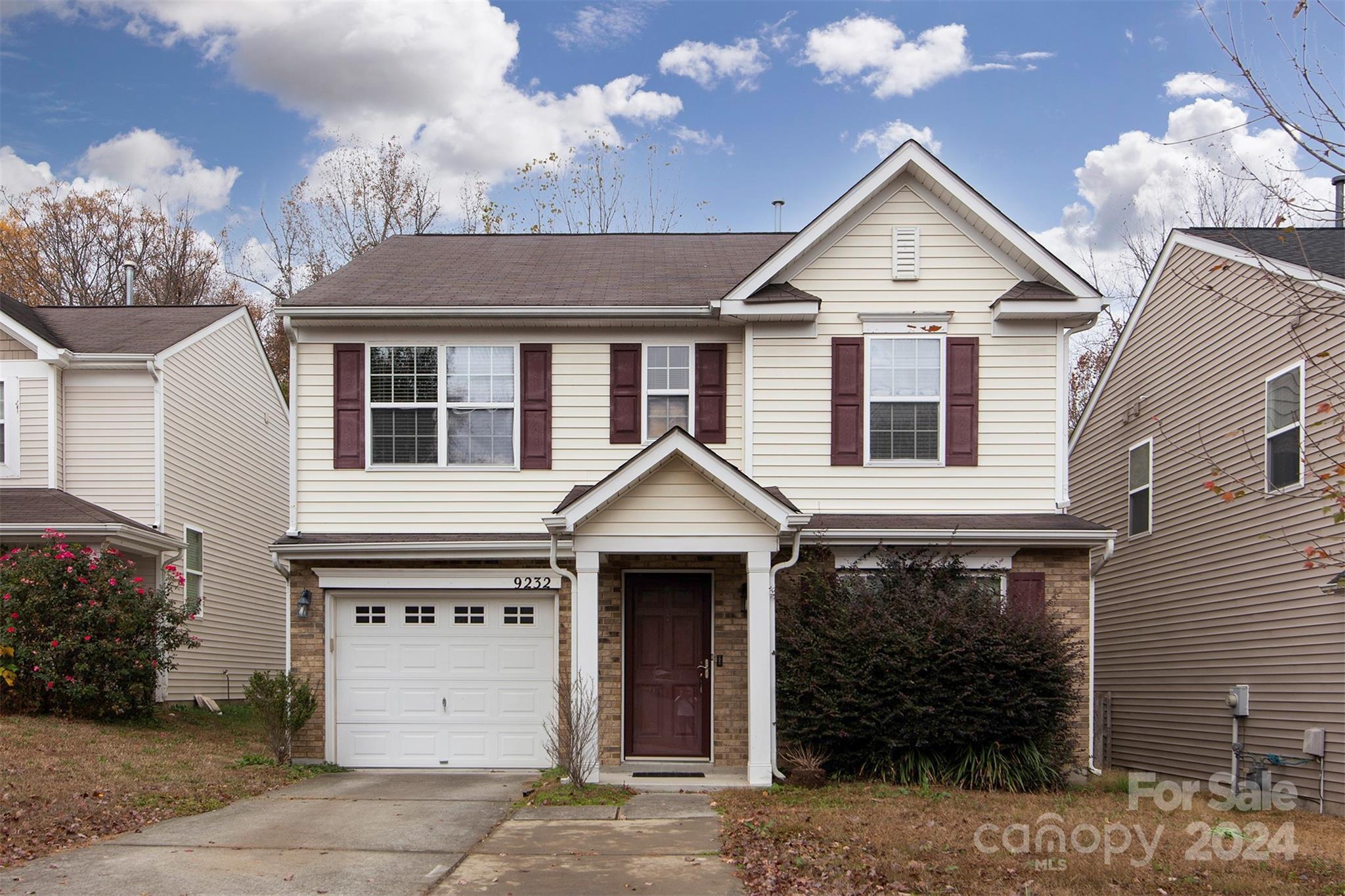 a front view of a house with a yard and garage