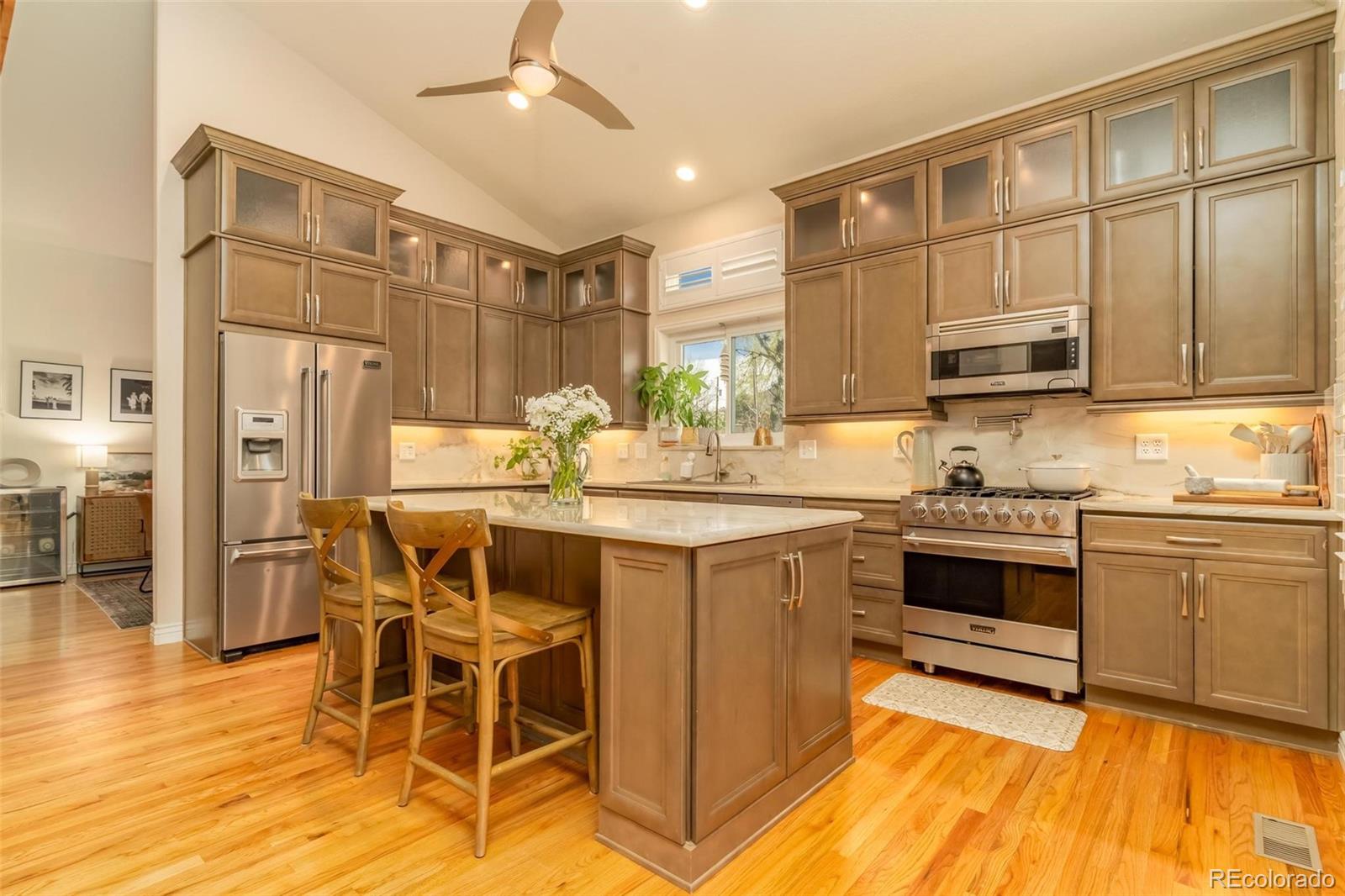 a kitchen with stainless steel appliances granite countertop a stove and cabinets