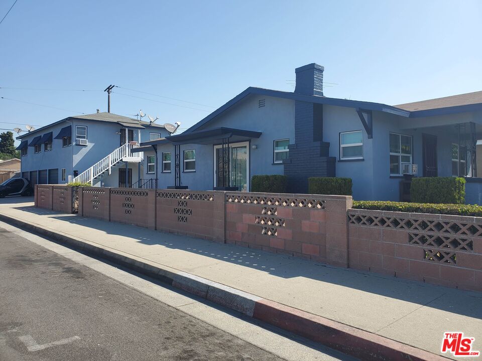 a view of house with wooden fence