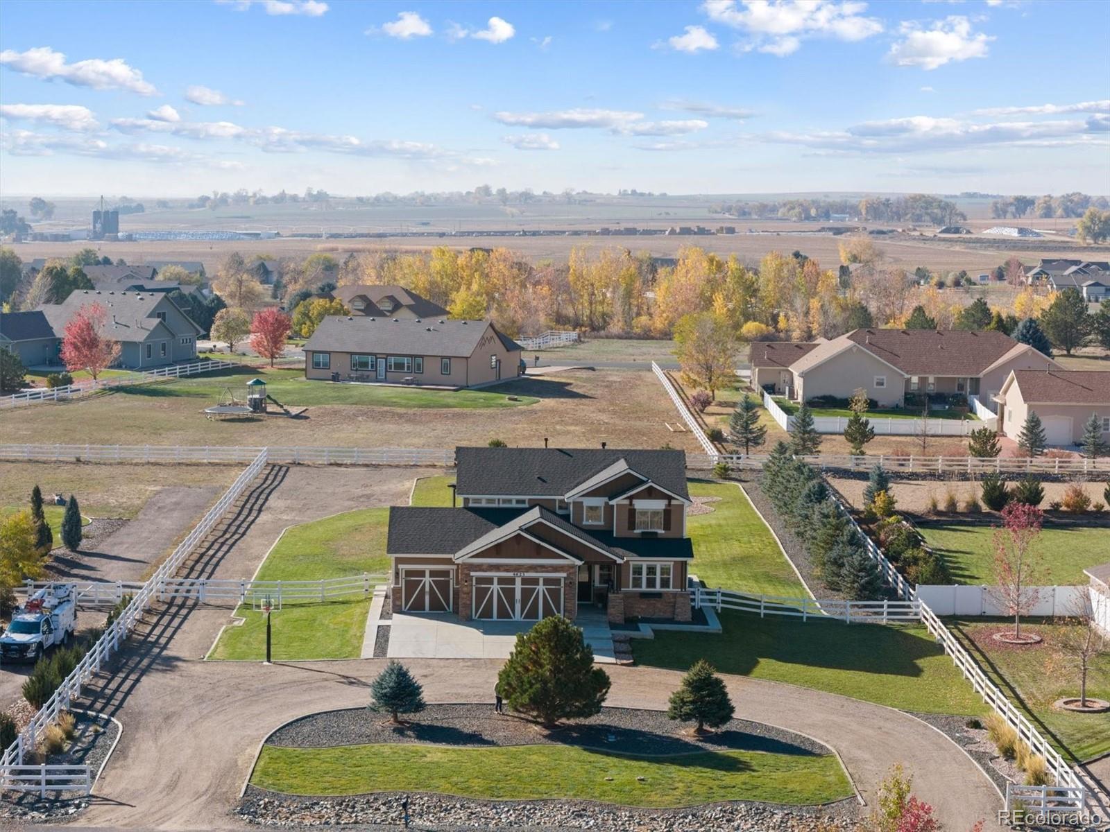 an aerial view of residential houses with outdoor space and swimming pool