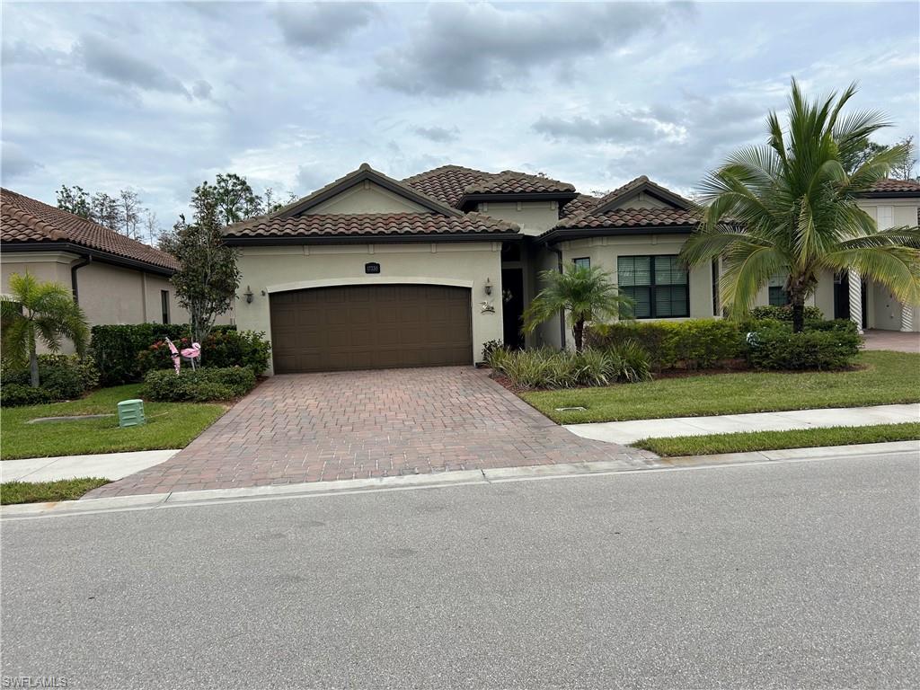 a front view of a house with a yard and garage