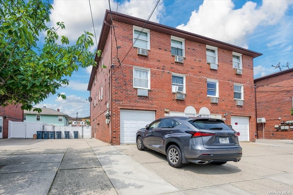 a car parked in front of a brick house