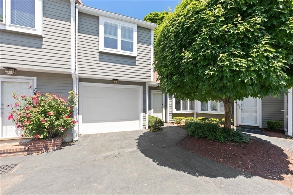 a front view of a house with a yard and a garage