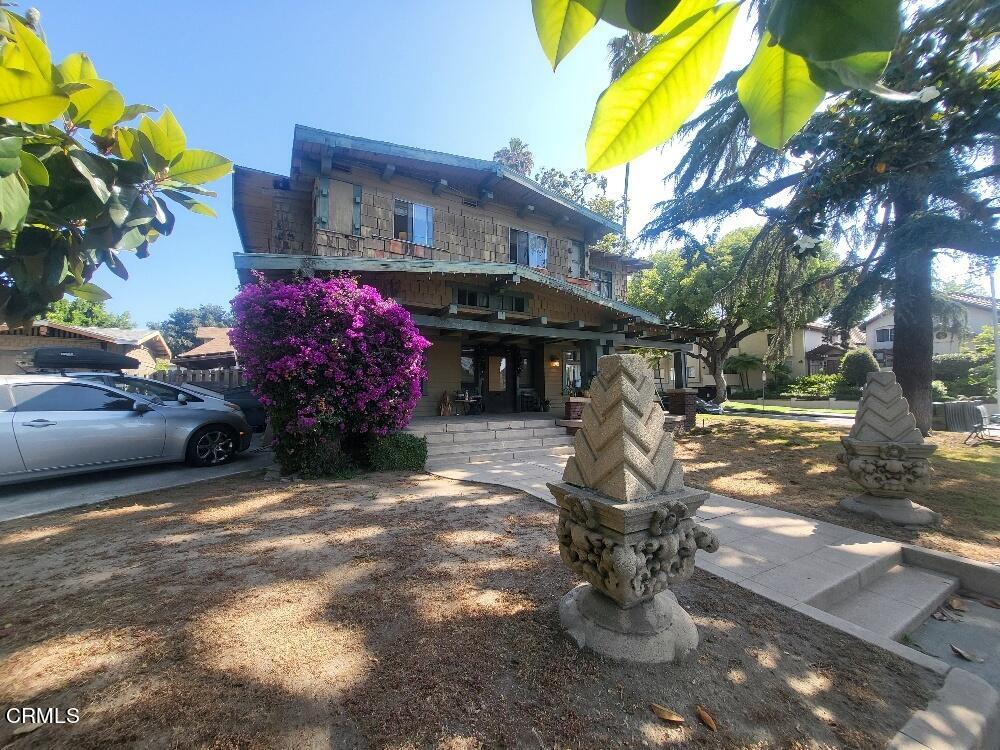 a front view of a house with a yard and outdoor seating