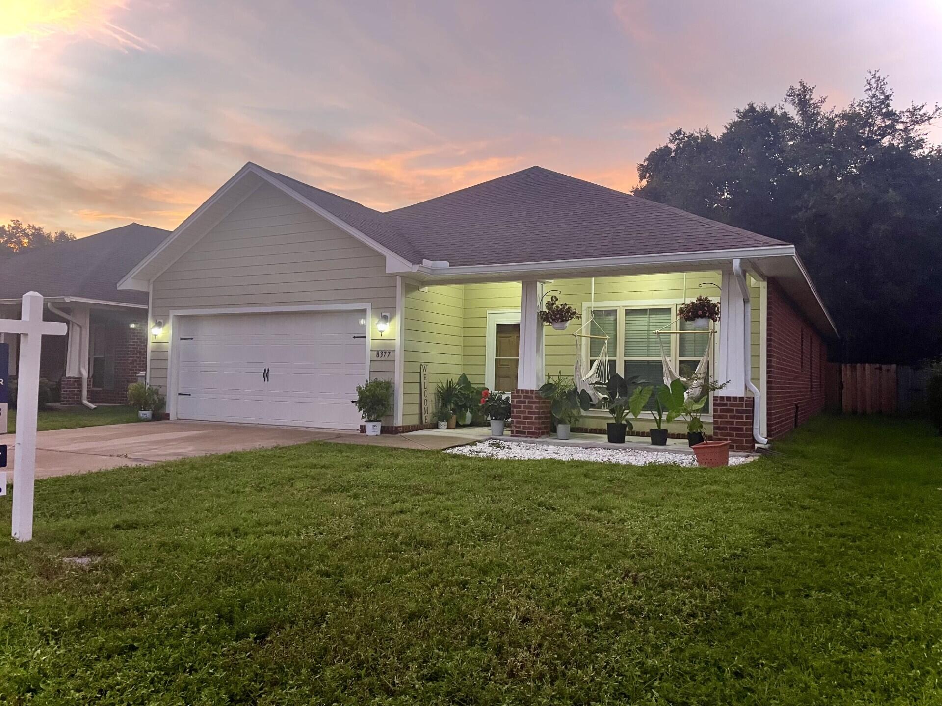 a front view of a house with a yard and porch