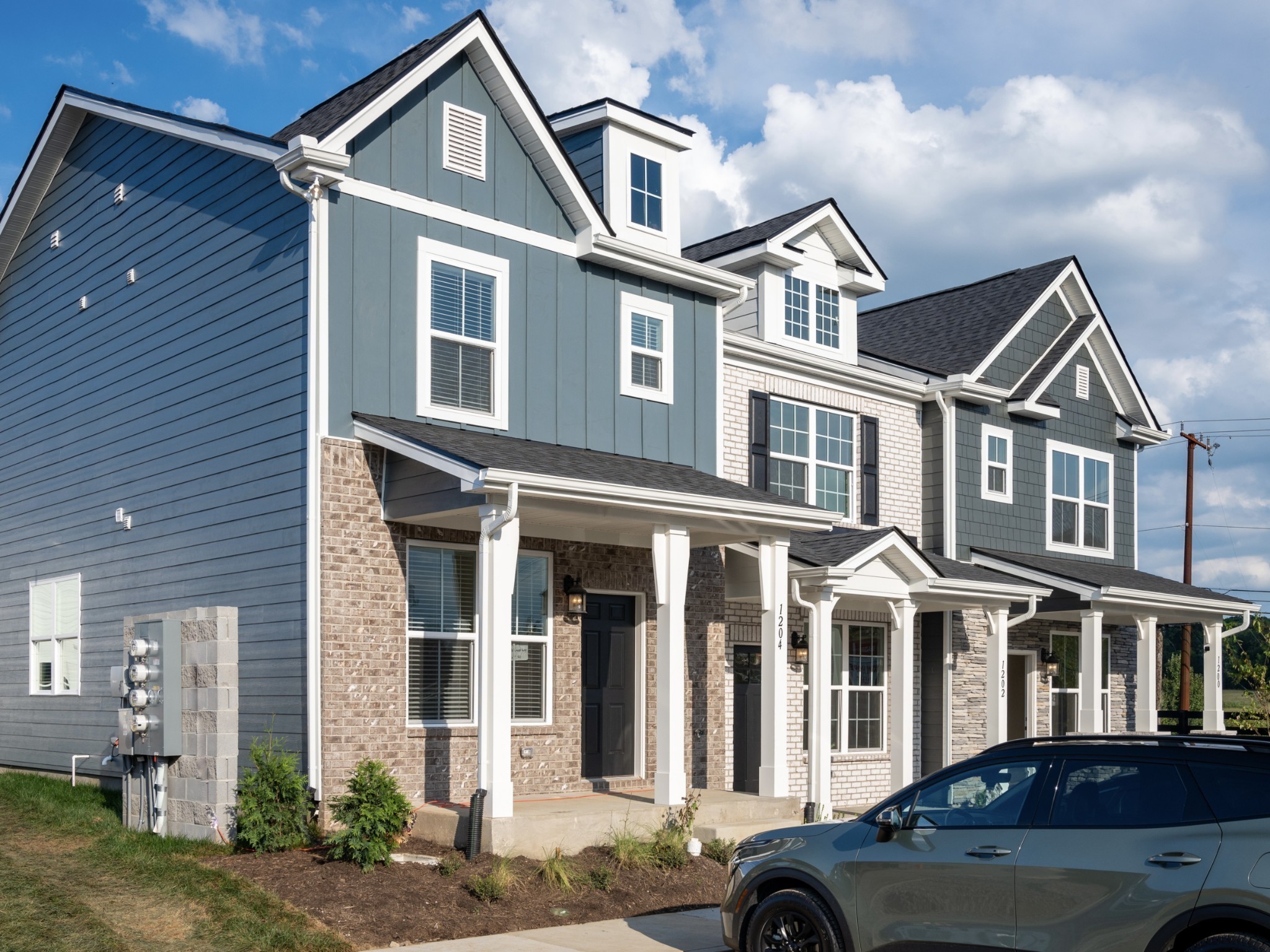 a front view of a residential apartment building with a yard