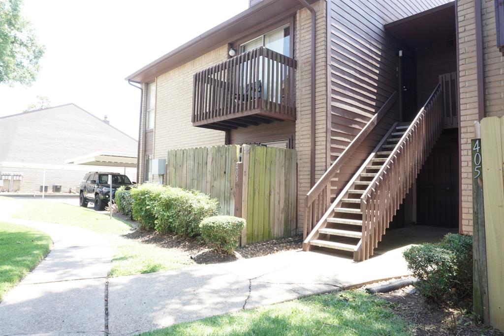 a view of a house with wooden floor in front of house