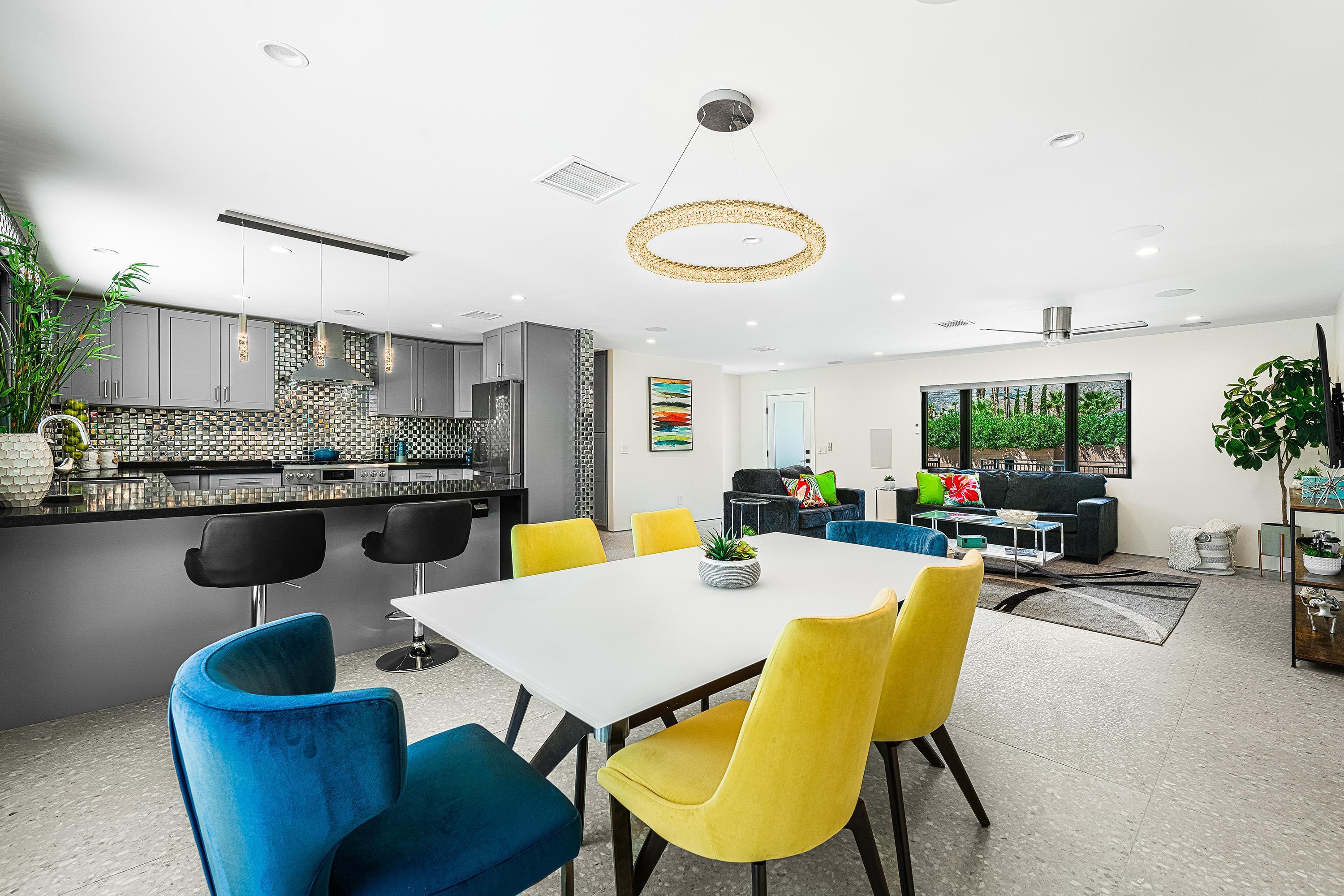 a view of a dining room with furniture and a kitchen