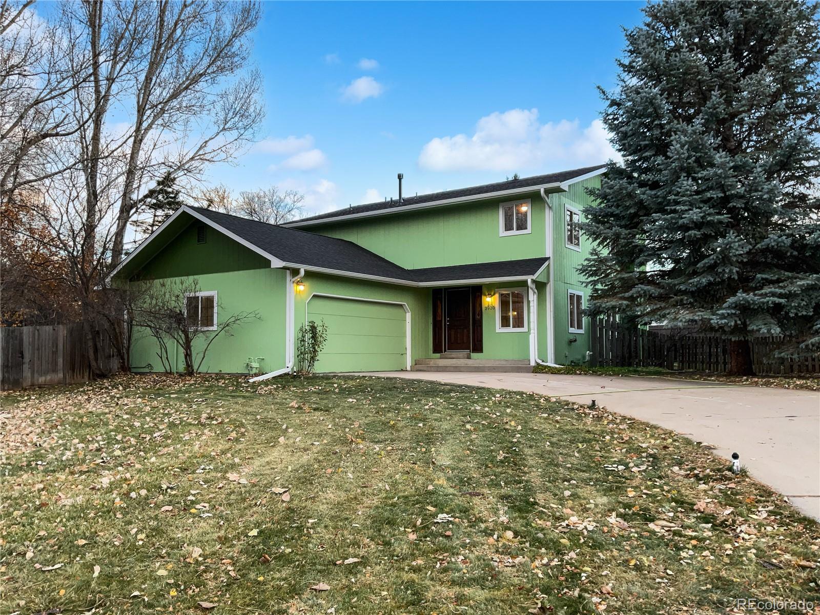 a view of a house with a yard and garage