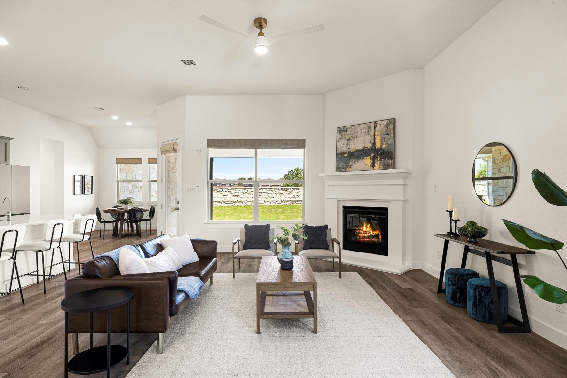 a living room with furniture a fireplace and a table