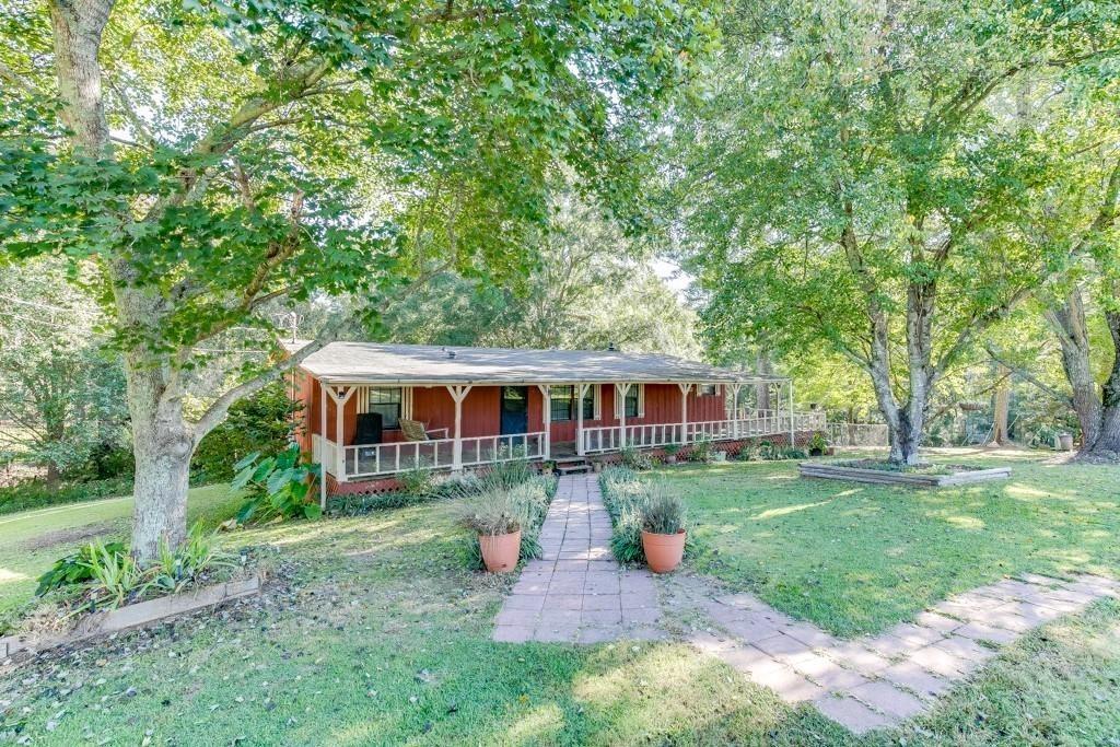 a front view of house with a garden and patio