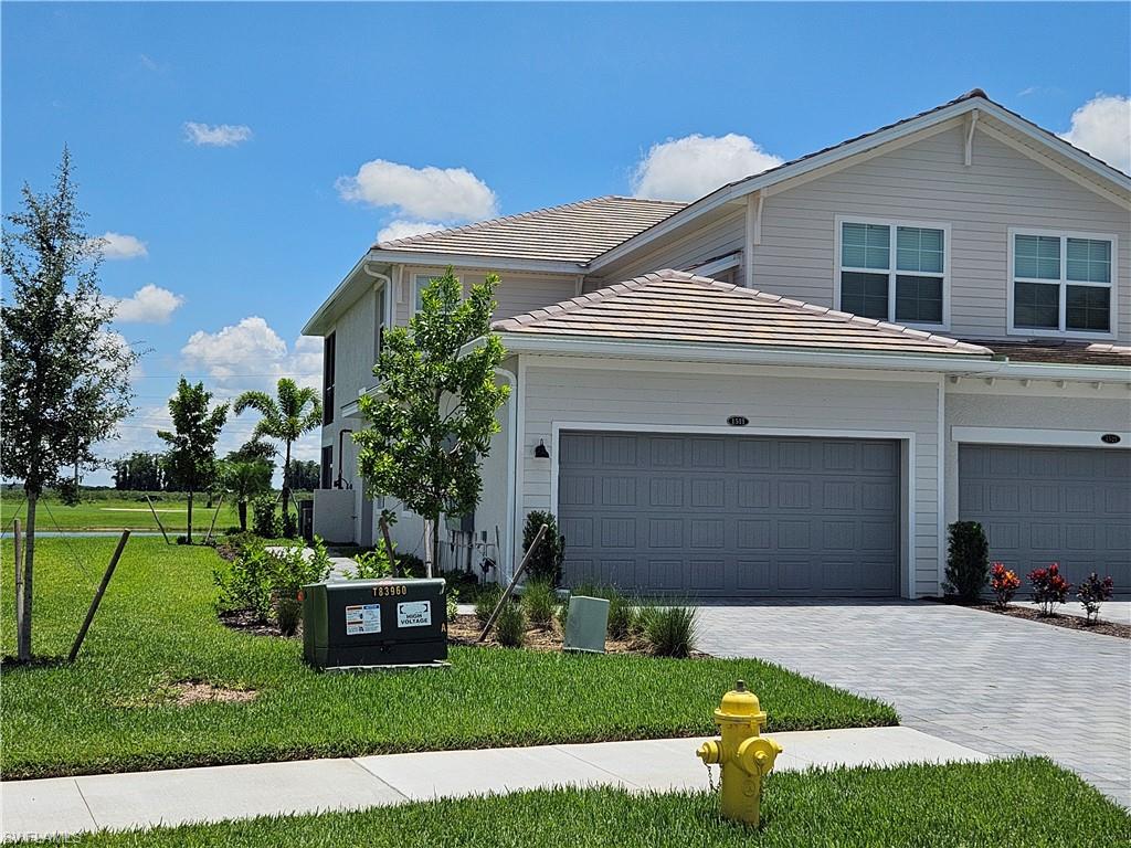 a front view of a house with a yard and garage