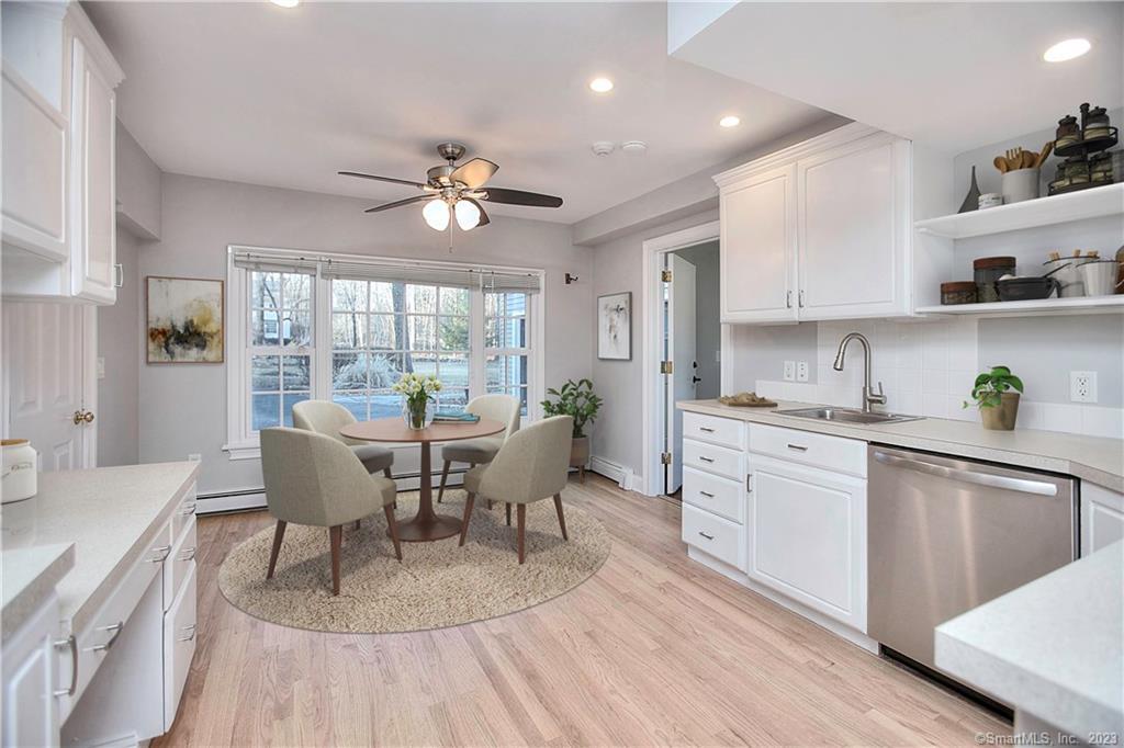 a view of a dining room with furniture a chandelier and wooden floor