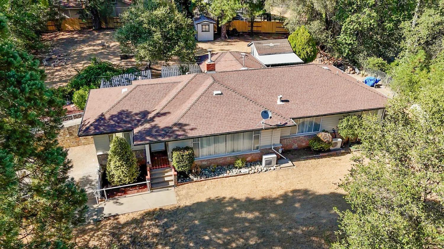 an aerial view of a house with a yard and balcony