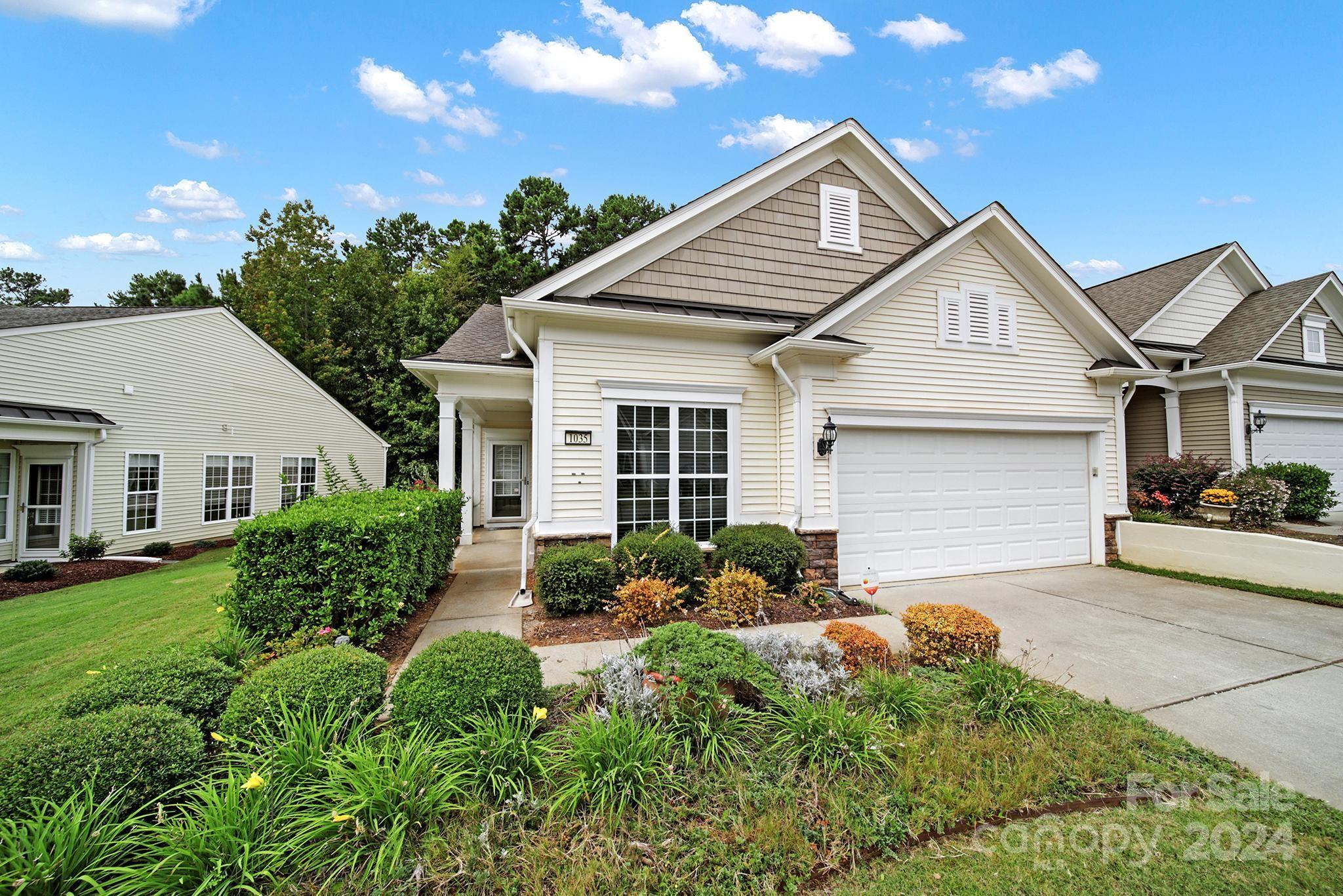 a front view of a house with garden