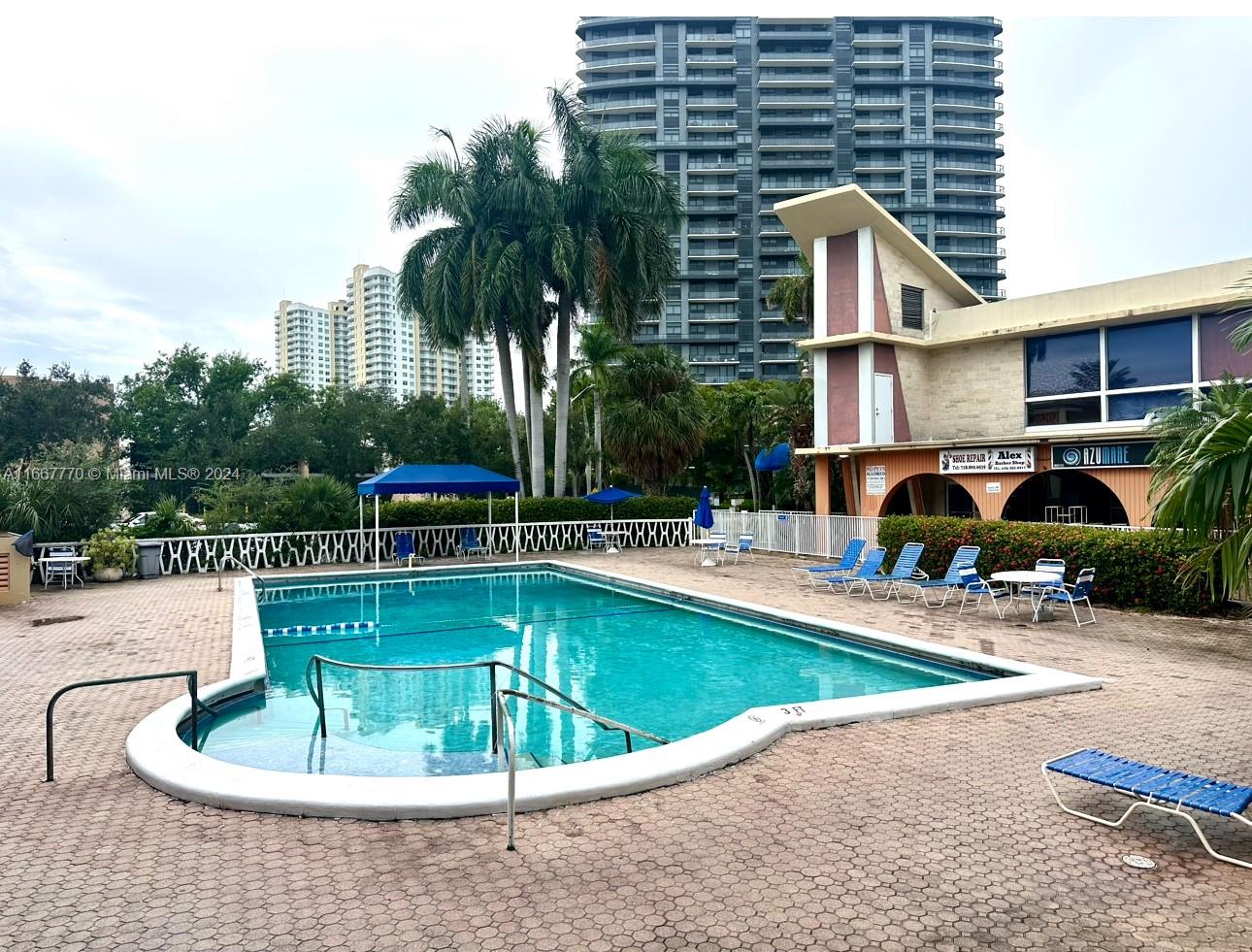 a swimming pool with outdoor seating and yard