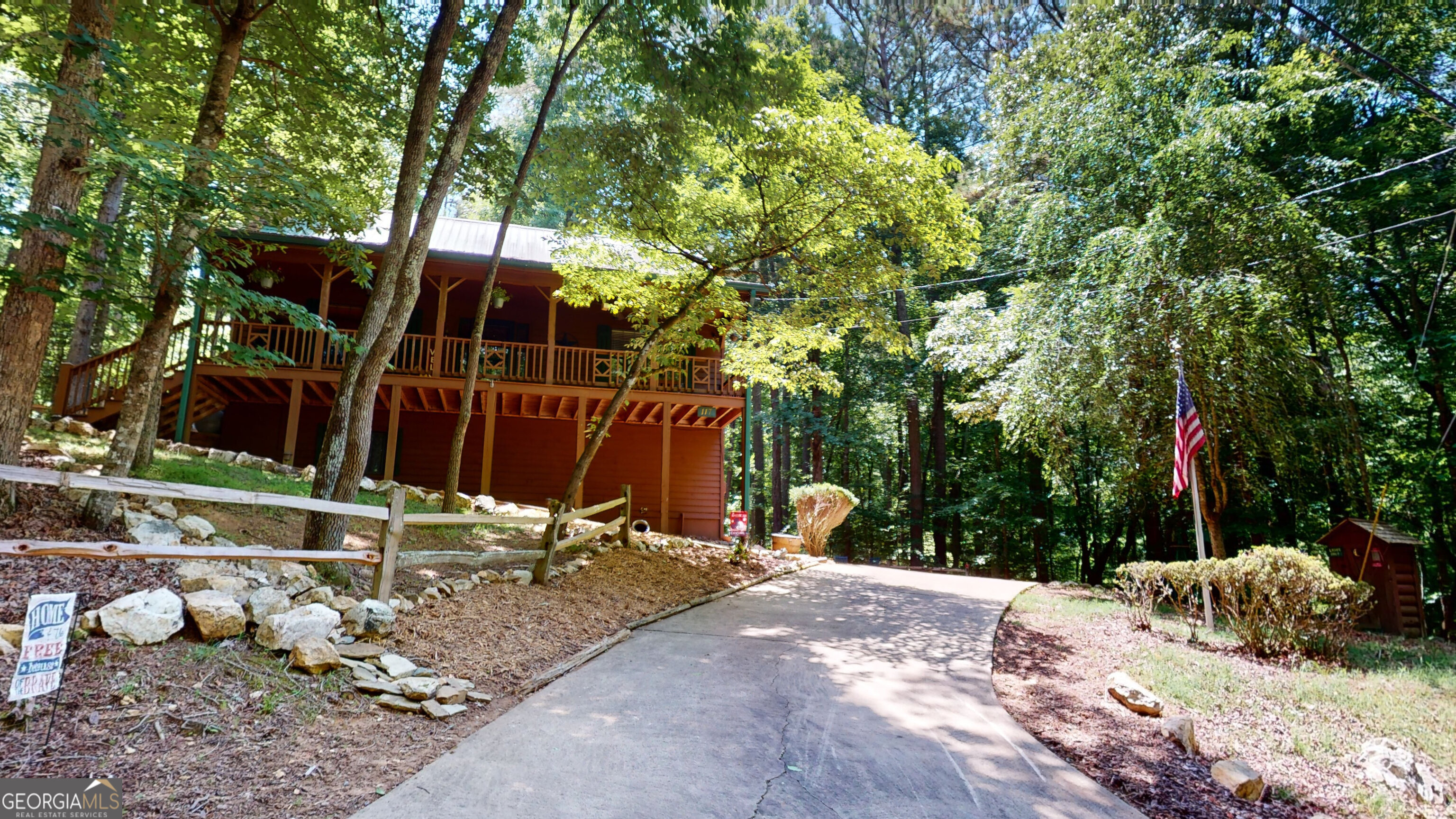 a view of a backyard with table and chairs and a large tree