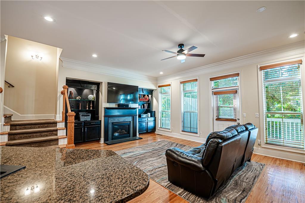 a living room with furniture and wooden floor