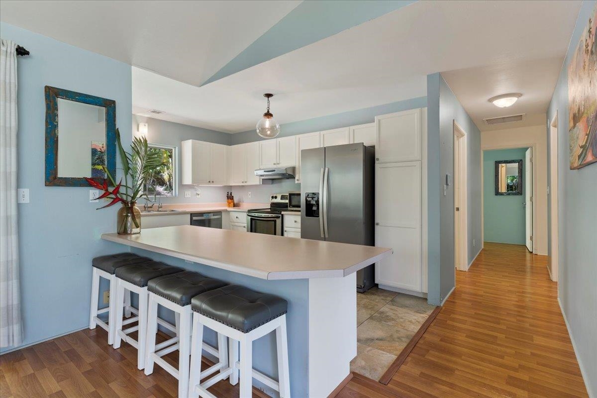 a kitchen with stainless steel appliances a sink and a refrigerator