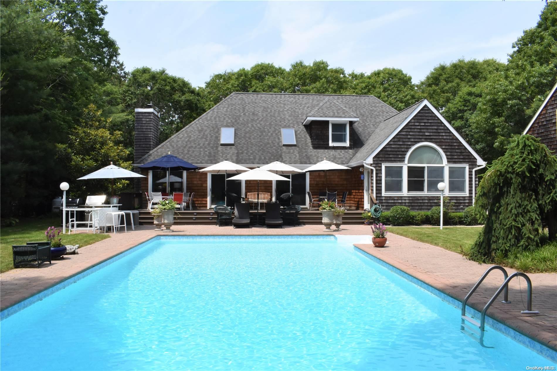 a front view of a house with swimming pool and porch