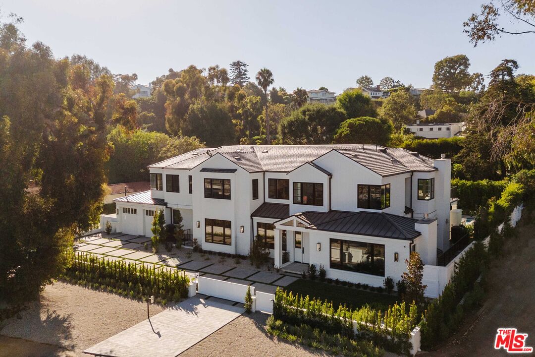 a aerial view of a house with a large trees