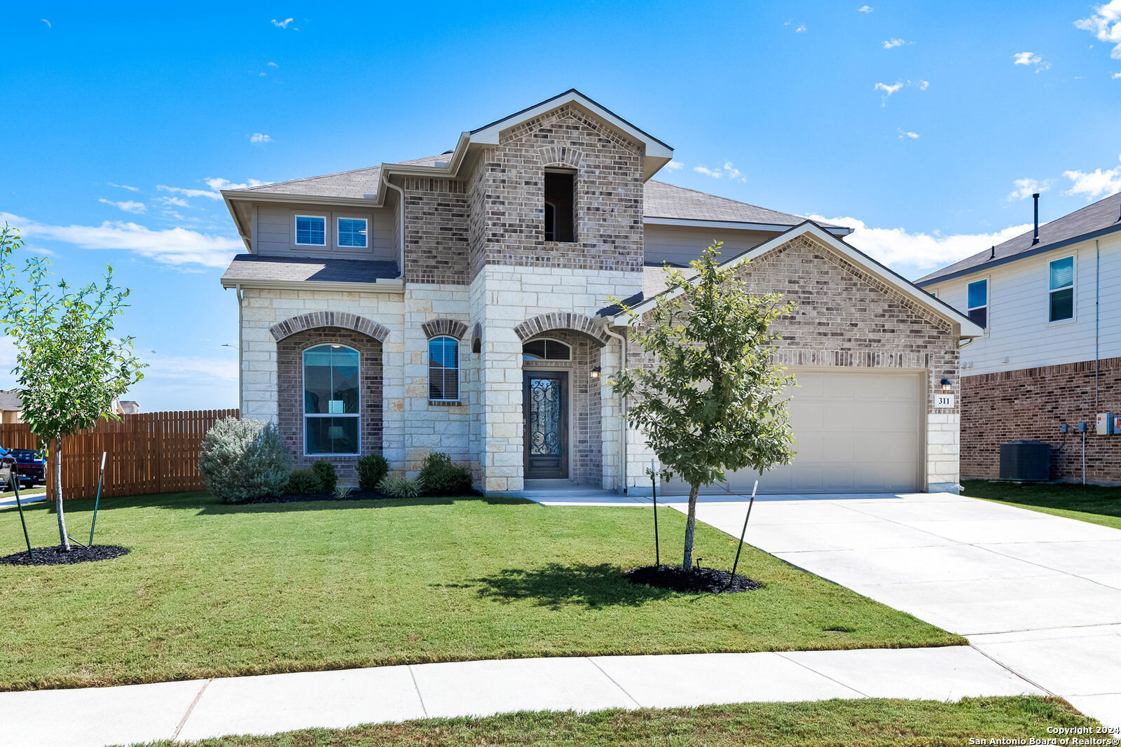 a front view of a house with a yard and garage