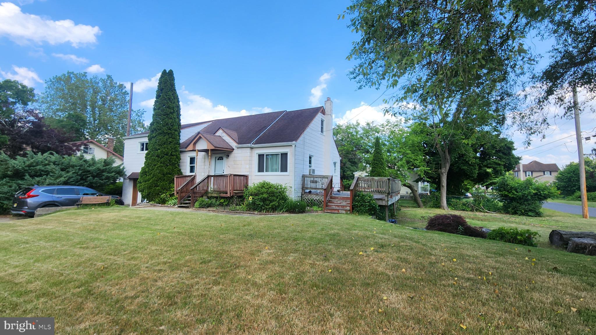 a view of a house with backyard and porch