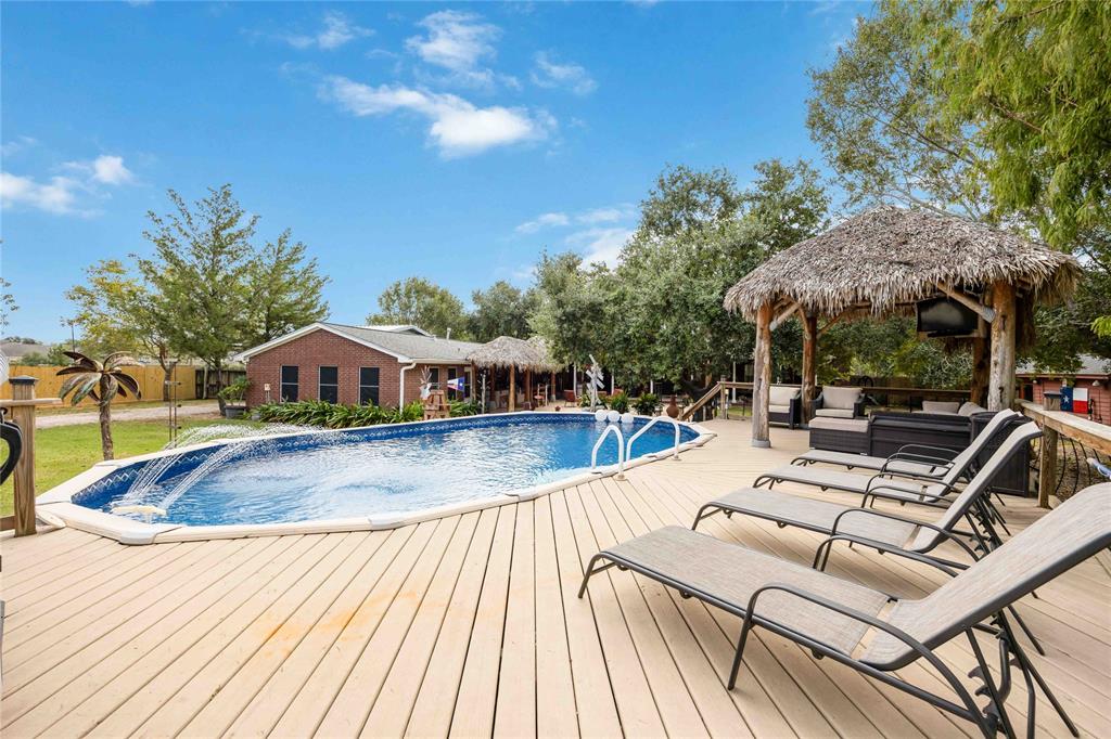 a view of a swimming pool with lounge chairs in patio