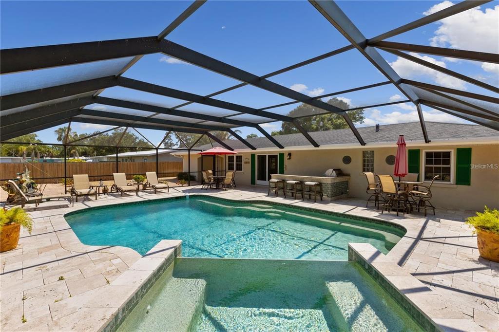 a view of a backyard with swimming pool