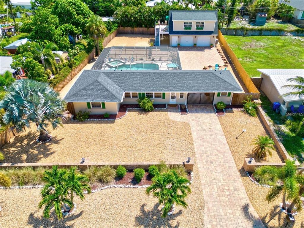 an aerial view of a house with a yard