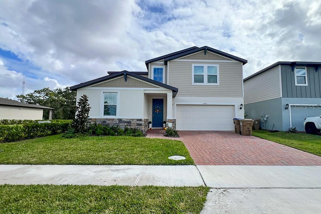 a front view of a house with a yard and garage