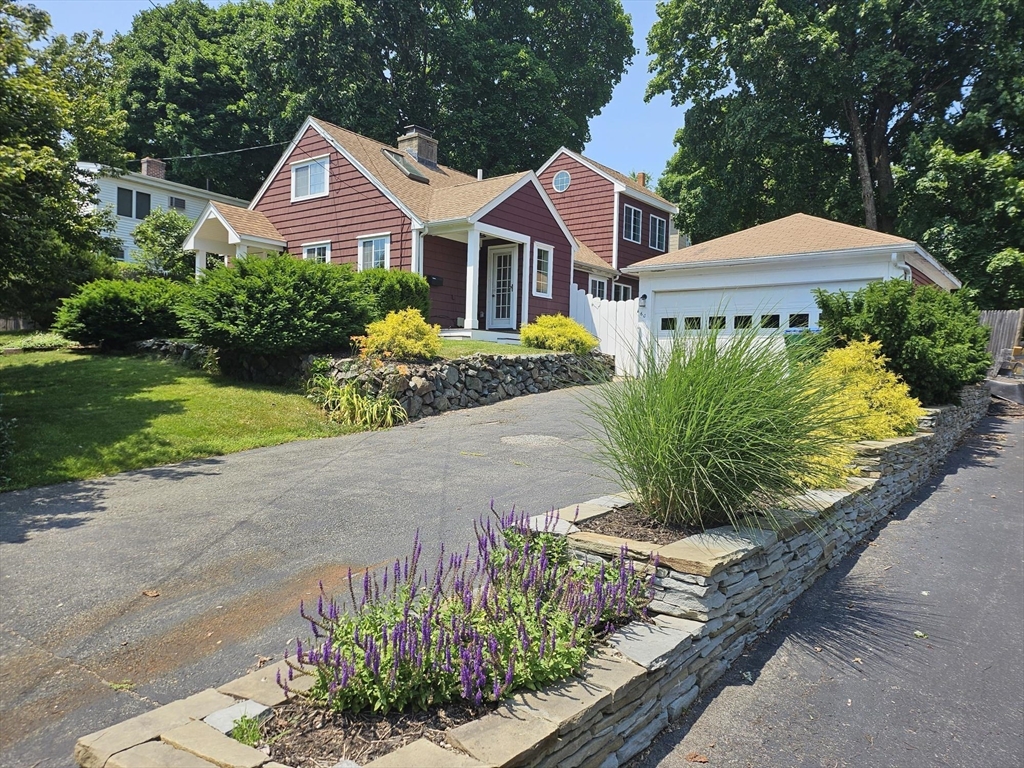 a front view of a house with a garden