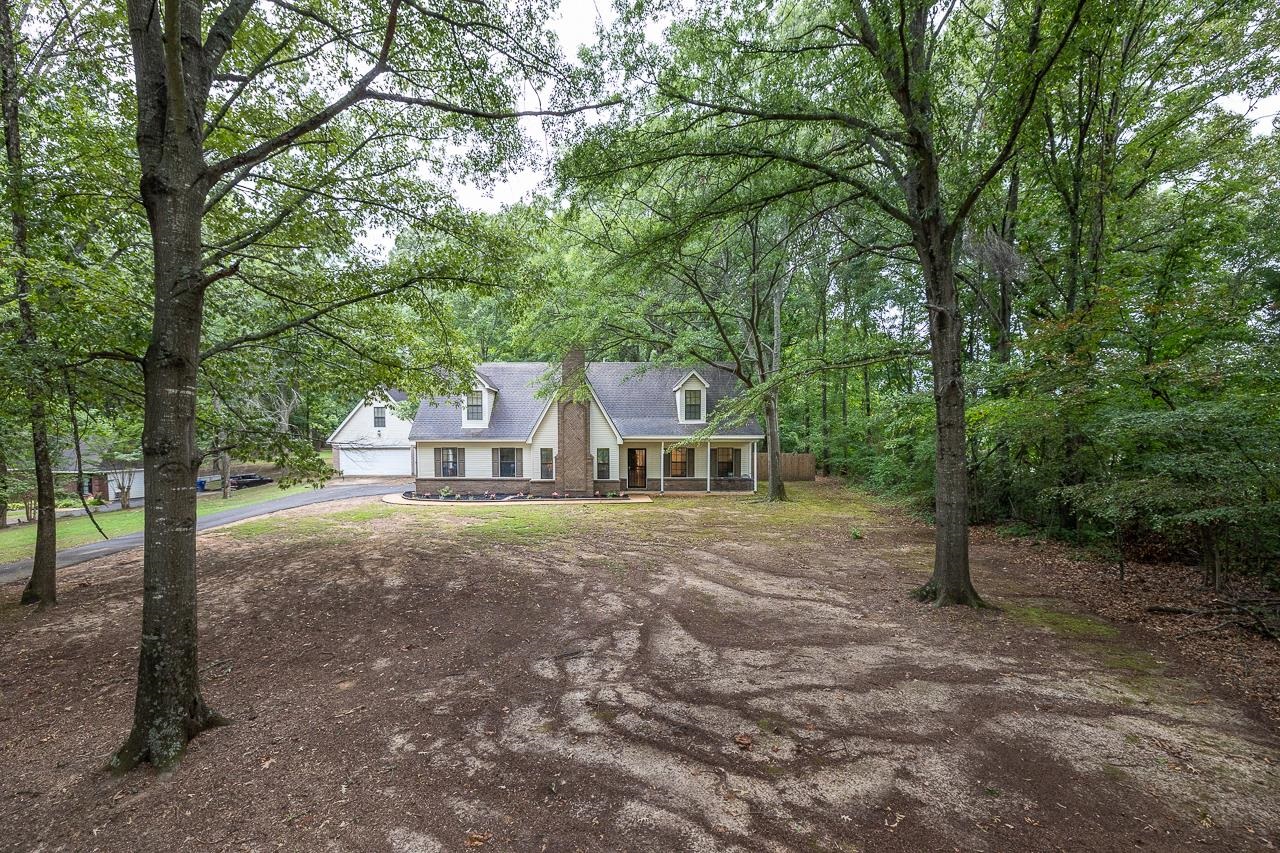 a view of a house with large trees