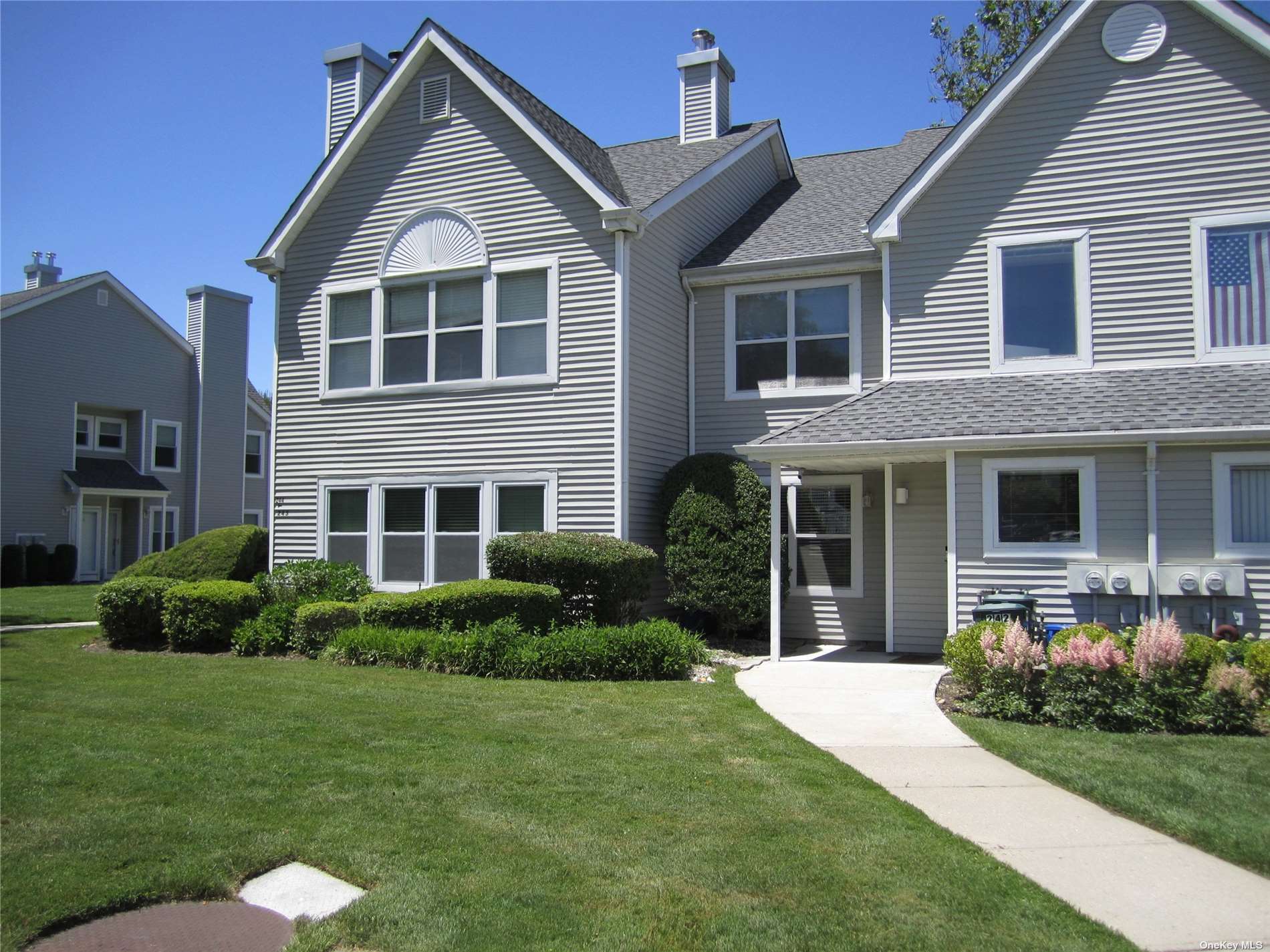 a view of a house with a yard and plants