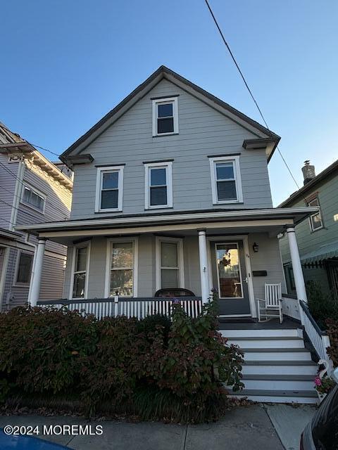 a front view of a house with plants