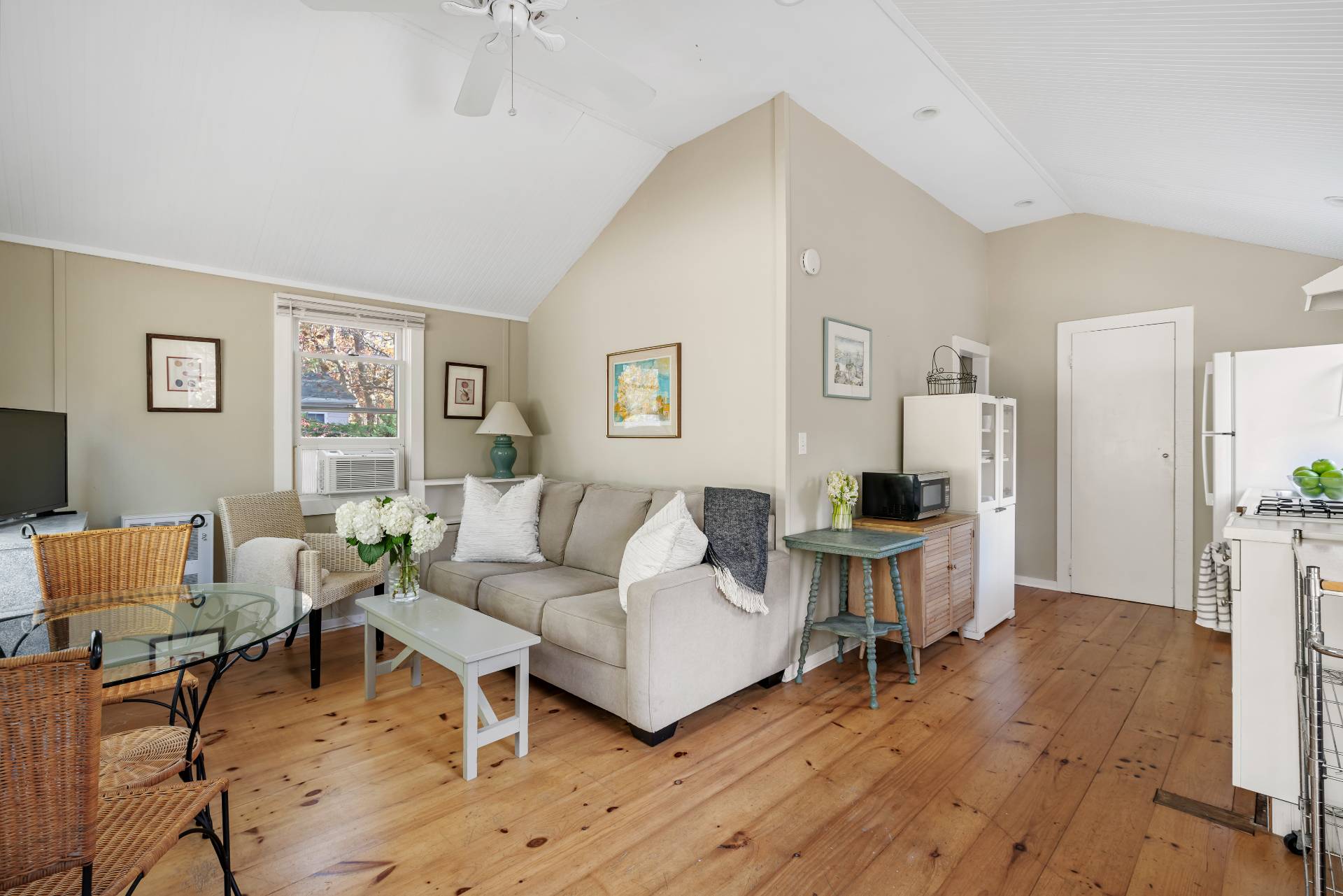 a living room with furniture wooden floor and a table