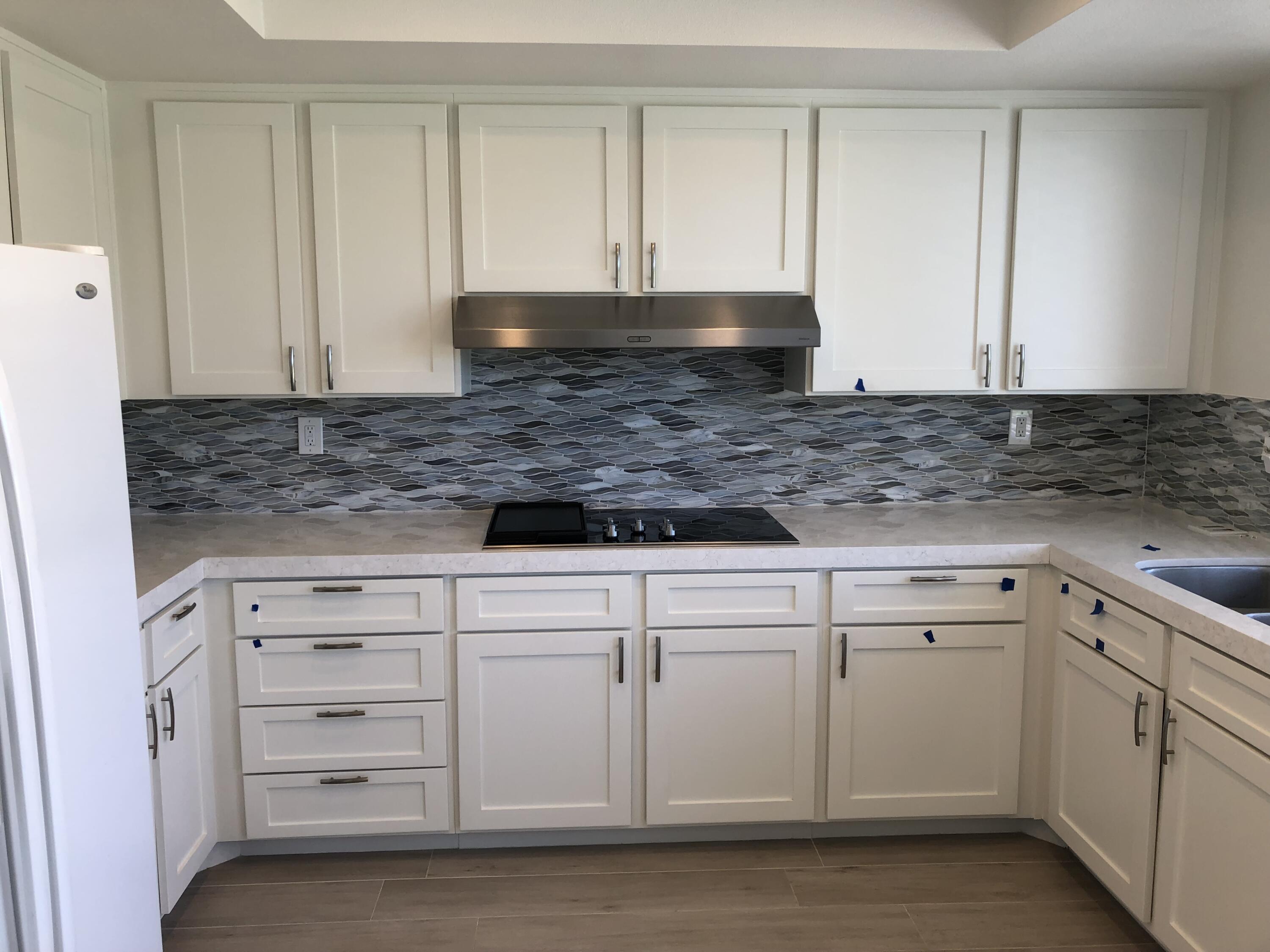 a view of a kitchen with granite countertop cabinets