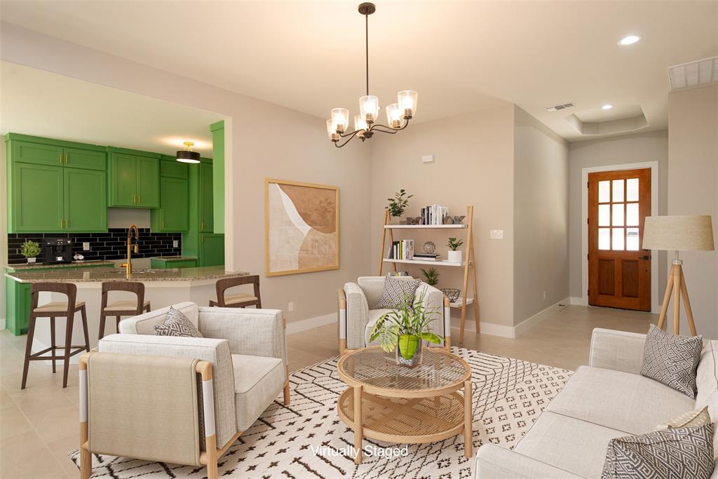 a living room with furniture a window and kitchen view