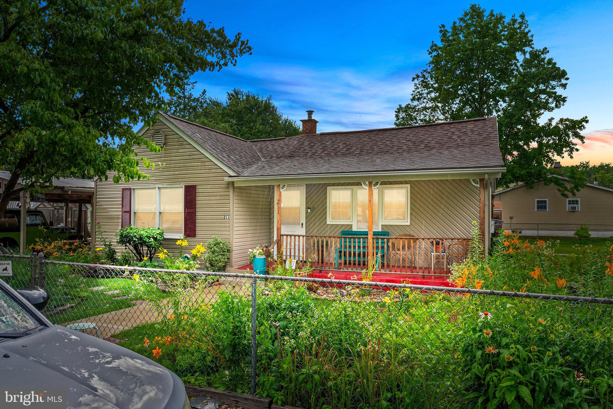 a view of an house with backyard space and garden