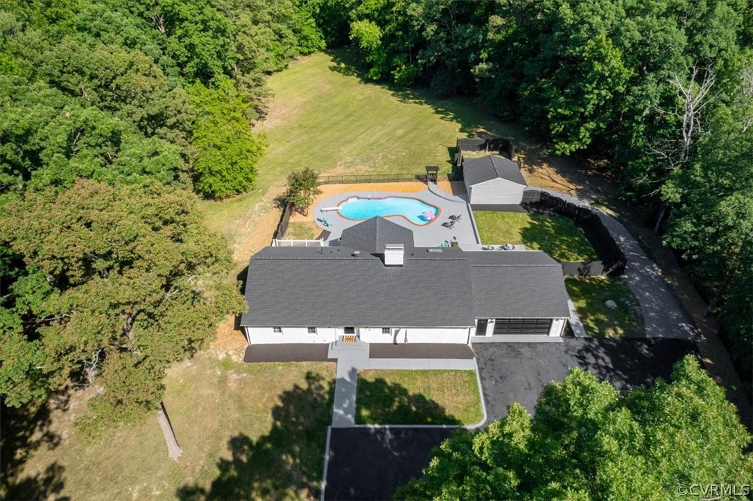 an aerial view of a house with a yard basket ball court