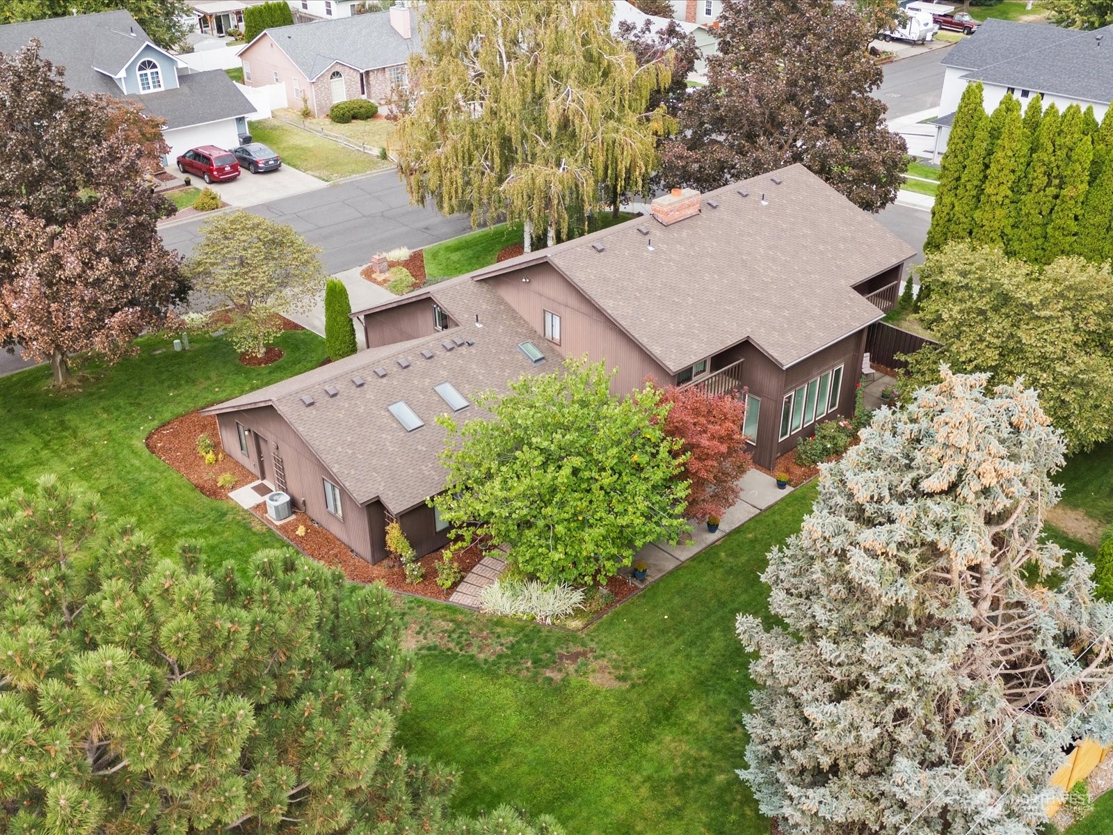 an aerial view of a house with garden space and street view