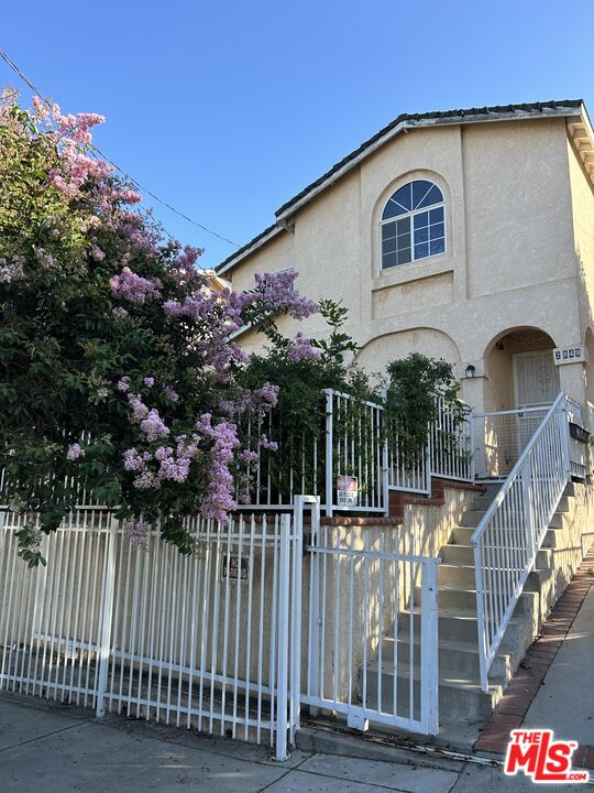 a front view of house along with deck and outdoor space