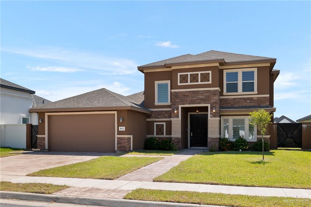 Prairie-style house with a garage and a front lawn