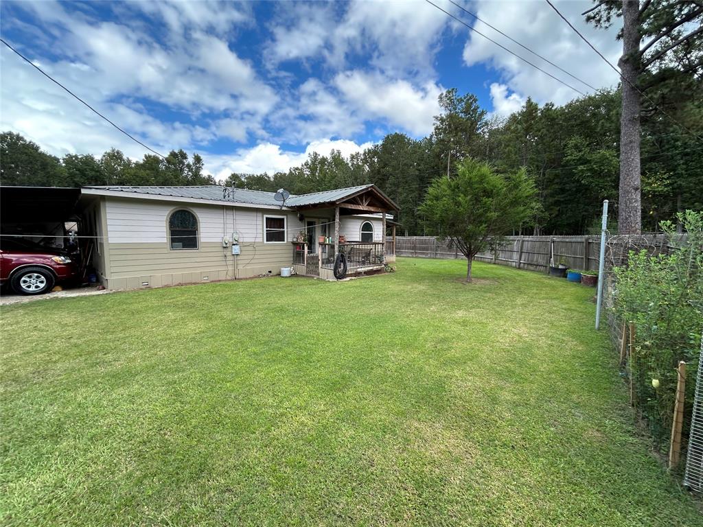 a view of a house with a yard and sitting area