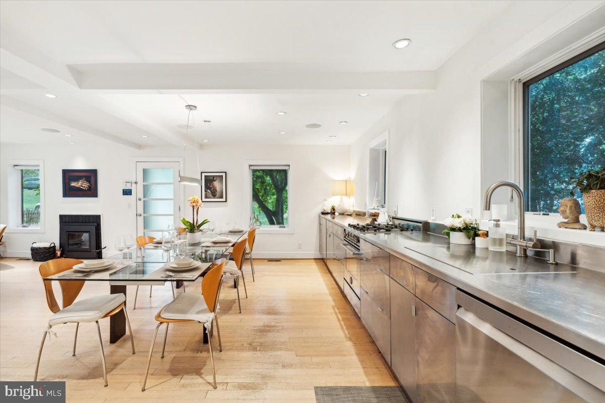 a very nice looking open dining room with kitchen island furniture and a wooden floor