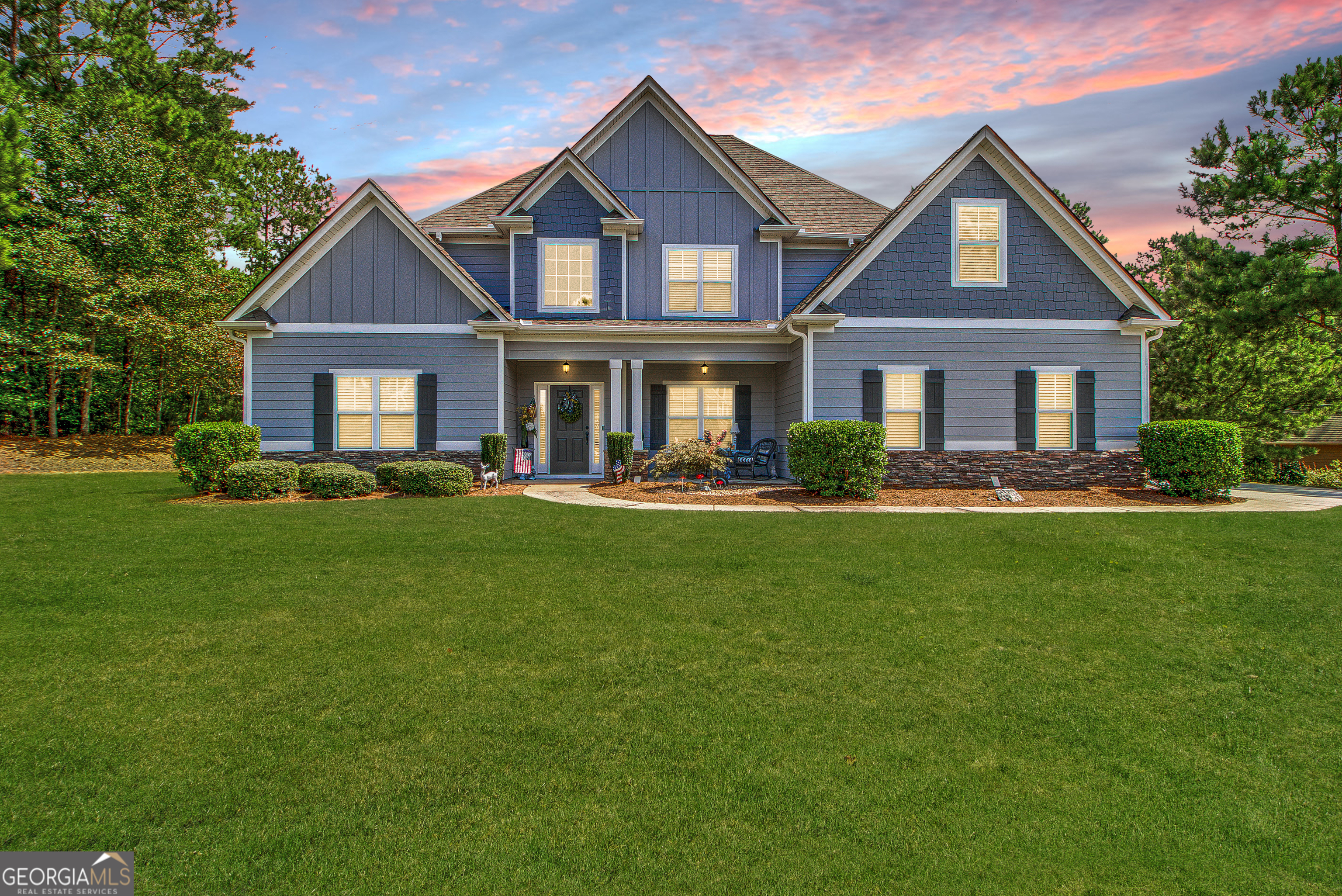 a front view of house with yard and green space