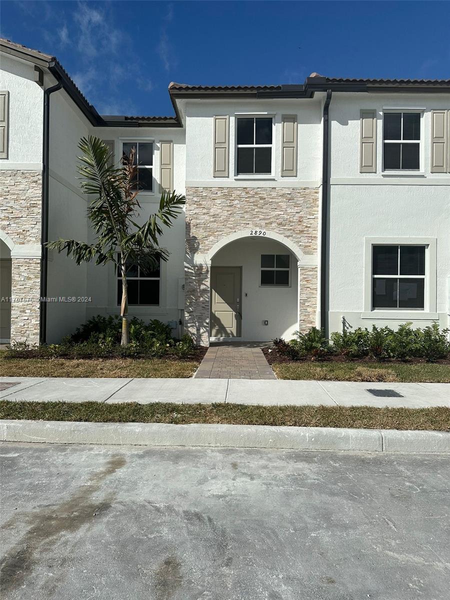 a view of a house with a yard and plants