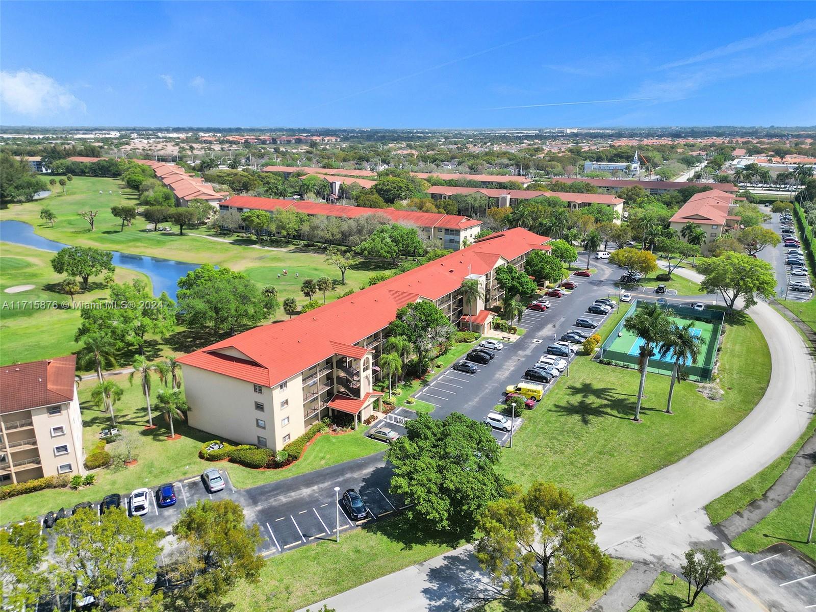 an aerial view of a house with a garden and lake view