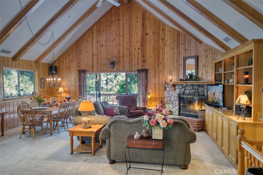 a living room with furniture a fireplace and a large window